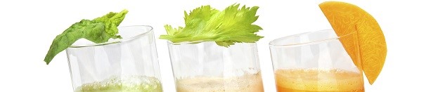 fresh juices from carrot, celery and parsley in glasses isolated on white
